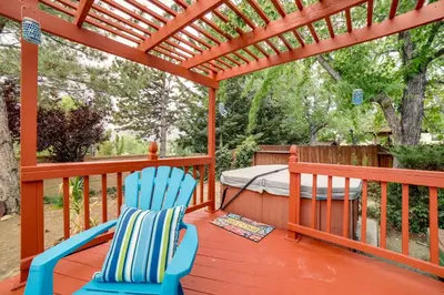 a deck with two chairs and a bed and a pergola at Pet-Friendly Home with Hot Tub! 6 Mi to Dtwn Reno in Reno