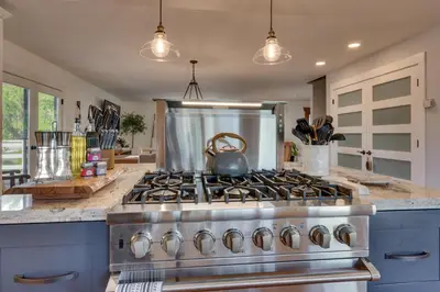 a kitchen with a stove with a tea kettle on it at @ Marbella Lane - Eccentric 4BR Modern Ranch Home in Reno