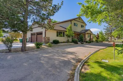 a house on a street with a driveway at @ Marbella Lane - Eccentric 4BR Modern Ranch Home in Reno