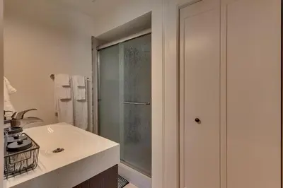 a bathroom with a shower and a white sink at @ Marbella Lane - Eccentric 4BR Modern Ranch Home in Reno
