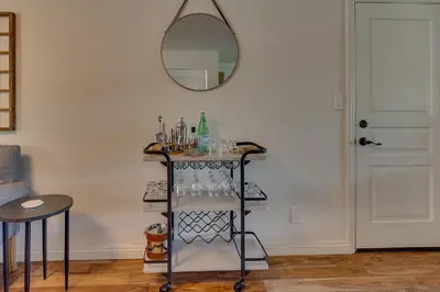 a shelf with glasses and a mirror in a room at @ Marbella Lane - Eccentric 4BR Modern Ranch Home in Reno