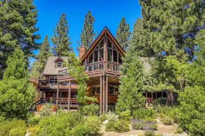 a large wooden house in the woods with trees at EJ's Point Walk to Beach in Tahoe City