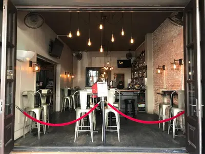 a red ribbon is tied in front of a bar at Hotel Sutter in Sutter Creek