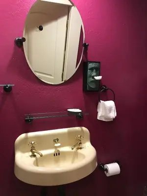 a bathroom with a sink and a mirror at Hotel Sutter in Sutter Creek