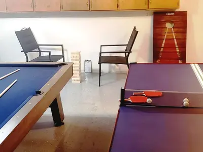 a ping pong table and two chairs in a room at Oasis Riverfront House -10 min to Sequoia in Three Rivers