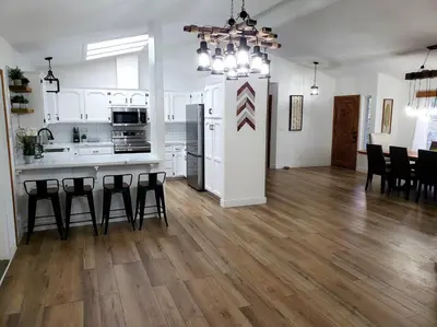a kitchen and living room with a table and chairs at Oasis Riverfront House -10 min to Sequoia in Three Rivers