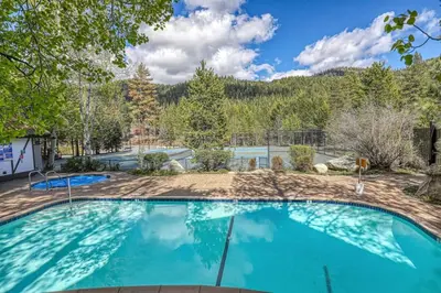 a large swimming pool with blue water at 2BDR Condo - Three Minutes to Olympic Valley! in Tahoe City