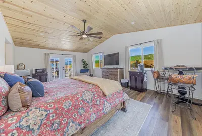 a bedroom with a bed and a wooden ceiling at Hidden Falls Retreat Peaceful Guesthouse Near Yosemite in Oakhurst