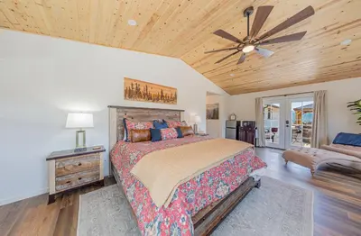 a bedroom with a bed and a ceiling fan at Hidden Falls Retreat Peaceful Guesthouse Near Yosemite in Oakhurst