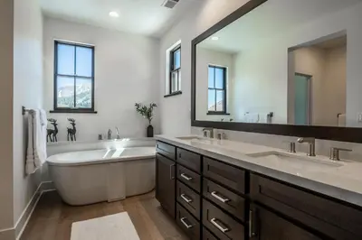 a bathroom with two sinks and a tub and a large mirror at Creekhouse 1342 in Mammoth Lakes