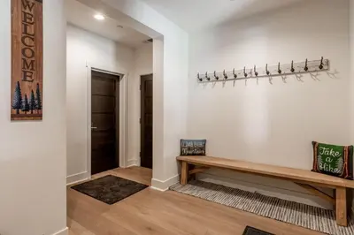 a hallway with a wooden bench on a wall at Creekhouse 1342 in Mammoth Lakes
