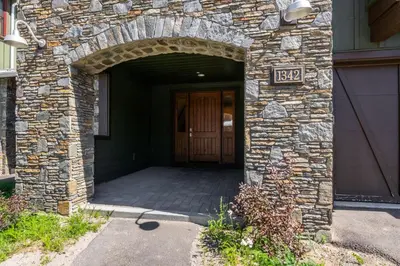 an entrance to a stone building with a door at Creekhouse 1342 in Mammoth Lakes