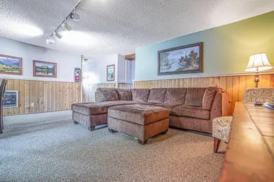 a living room with a couch and a table at Mammoth Lakes Condo with Fireplace and Mountain Views in Mammoth Lakes