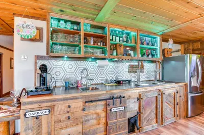 a kitchen with wooden cabinets and a refrigerator at Game Room, Mtn Views! Unit 1 Mi to Heavenly Resort in Stateline