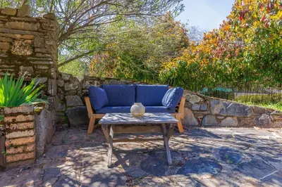 a blue couch and a coffee table on a patio at The Haven -In Town, NEWLY remodeled, Private, Stocked in Mariposa