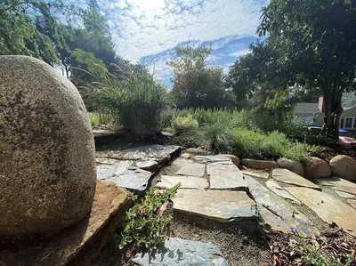 a garden with rocks and plants in a yard at The Haven -In Town, NEWLY remodeled, Private, Stocked in Mariposa