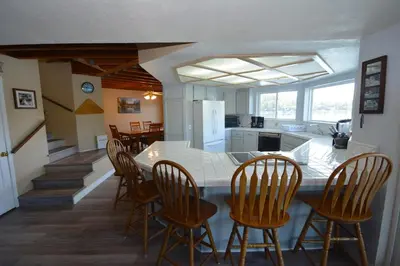 a kitchen and dining room with a table and chairs at Beautiful Lakefront Home Spectacular View - Herrera in Bass Lake