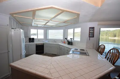 a kitchen with a table and a counter top at Beautiful Lakefront Home Spectacular View - Herrera in Bass Lake