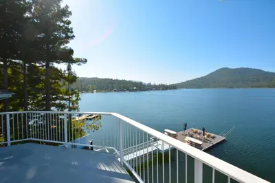 a balcony with a view of a lake at Beautiful Lakefront Home Spectacular View - Herrera in Bass Lake