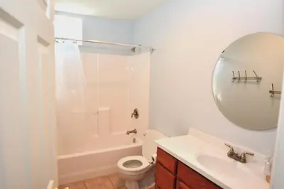 a bathroom with a sink and a toilet and a mirror at Beautiful Lakefront Home Spectacular View - Herrera in Bass Lake