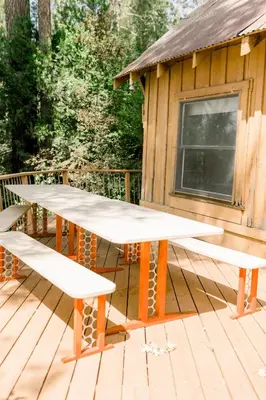 two picnic tables on a deck in front of a cabin at Dupzyk Lake Front Reduced Nightly Rate in Bass Lake