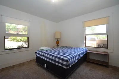 a bedroom with a bed and two windows at Dupzyk Lake Front Reduced Nightly Rate in Bass Lake