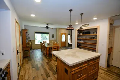 a kitchen with a counter and a dining room at Walter- Lake AreaFree Night Special in Bass Lake