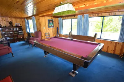 a pool table in the middle of a room at O'Connell-Lake Area Free Night Special in Bass Lake