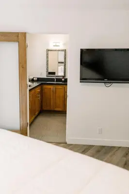 a bedroom with a large flat screen tv on a wall at Werner Lake Front in Bass Lake