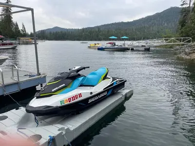 a jet ski parked at a dock in the water at Werner Lake Front in Bass Lake