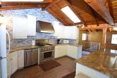 a kitchen with white cabinets and a stove top oven at O'Hara Lake View in Bass Lake