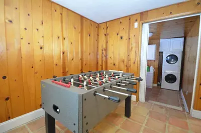 a foosball table in a room with wooden walls at O'Hara Lake View in Bass Lake