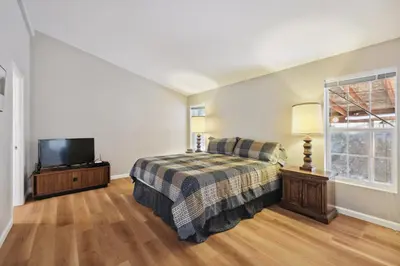 a bedroom with a bed and a flat screen tv at Newly Renovated Retreat on 6 Acres, Discover Murphys Lodge with Scenic Views! in Murphys