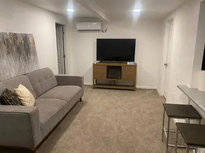 a living room with a couch and a flat screen tv at Entire cozy home in Madera
