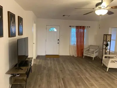 a living room with a flat screen tv and a couch at Entire cozy home in Madera