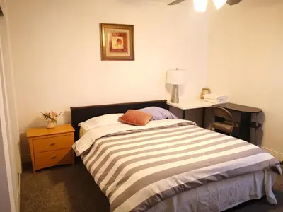 a small bedroom with a bed and a desk at Entire cozy home in Madera