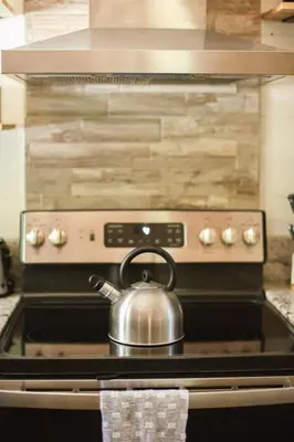 a tea kettle sitting on top of an oven at Sequoia Glen in Wilsonia