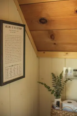 a bathroom with a calendar hanging on the wall at Sequoia Glen in Wilsonia