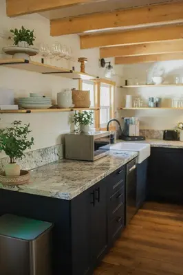 a kitchen with blue cabinets and a granite counter top at Sequoia Glen in Wilsonia