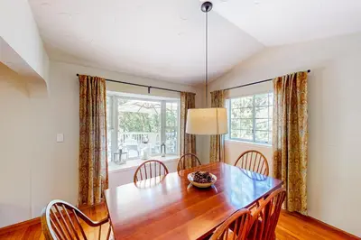 a dining room with a wooden table and chairs at The Lake Haus in Groveland