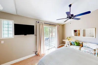 a bedroom with a bed and a tv and a couch at The Lake Haus in Groveland