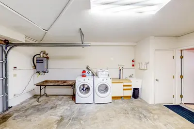 a laundry room with a washing machine and a table at The Lake Haus in Groveland