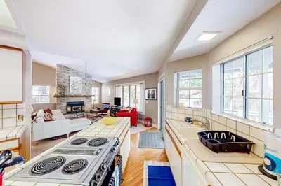 a kitchen with a stove and a living room at The Lake Haus in Groveland