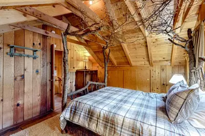 a bedroom with a bed in a wooden cabin at Pine Knolls in Tahoma