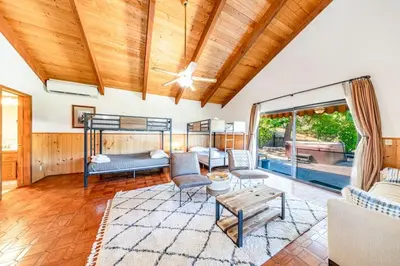 a living room with a wooden ceiling at Yosemite Cowboy Cabin in Oakhurst