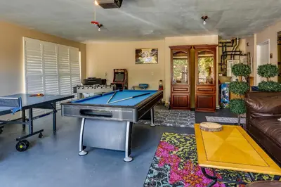 a living room with two ping pong tables and a couch at Pet-Friendly Coarsegold Vacation Rental with Deck! in Coarsegold