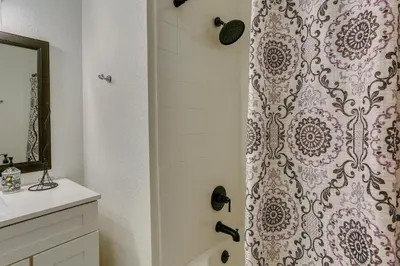 a bathroom with a shower curtain and a sink at Pet-Friendly Coarsegold Vacation Rental with Deck! in Coarsegold