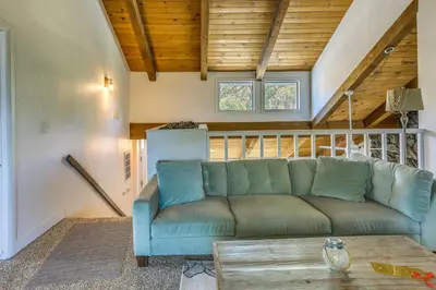 a living room with a couch and a table at Pet-Friendly Coarsegold Vacation Rental with Deck! in Coarsegold