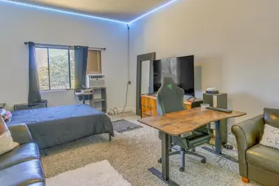 a bedroom with a bed and a desk and a tv at Pet-Friendly Coarsegold Vacation Rental with Deck! in Coarsegold