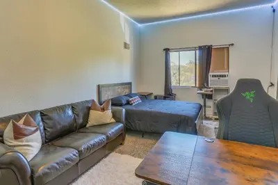 a living room with a couch and a table at Pet-Friendly Coarsegold Vacation Rental with Deck! in Coarsegold
